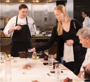 Chef explaining the menu to guests. 